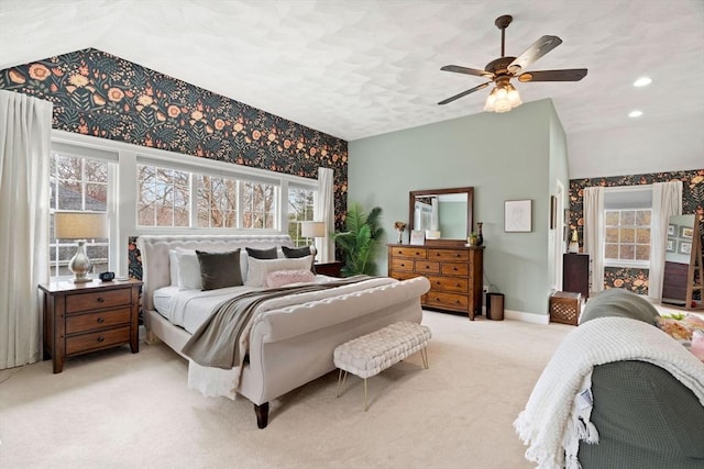 carpeted bedroom featuring baseboards, a ceiling fan, multiple windows, and lofted ceiling