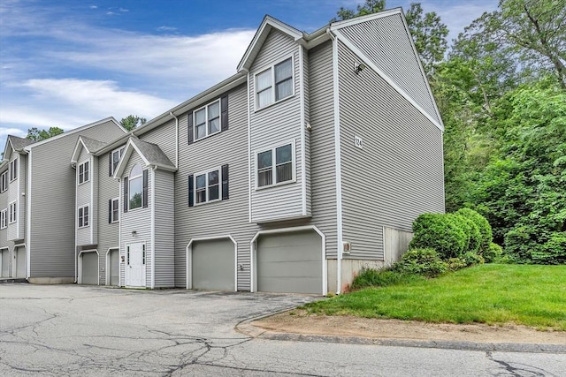 124 Tennis Plaza Rd Unit 2, Dracut, MA 01826 - view of side of property with driveway and a garage