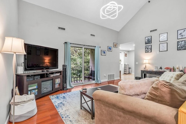 124 Tennis Plaza Rd Unit 2, Dracut, MA 01826 - living area with high vaulted ceiling, wood finished floors, and a chandelier