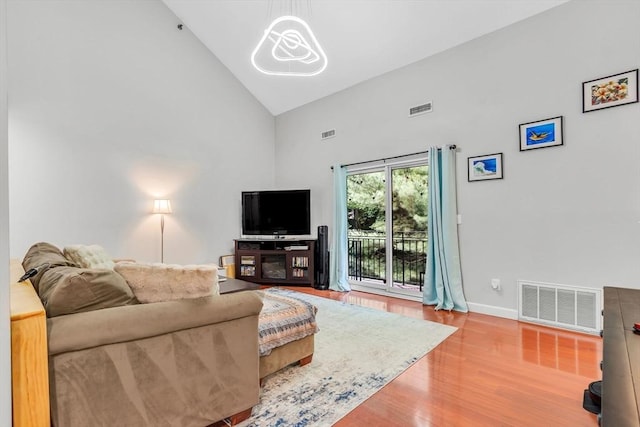 124 Tennis Plaza Rd Unit 2, Dracut, MA 01826 - living room featuring high vaulted ceiling, wood finished floors, and a chandelier