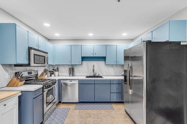 124 Tennis Plaza Rd Unit 2, Dracut, MA 01826 - kitchen featuring appliances with stainless steel finishes, blue cabinetry, light countertops, and recessed lighting