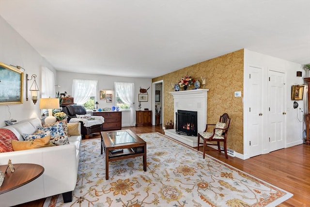 39 Bennets Neck Dr, Bourne, MA 02559 - living room with wood finished floors and a lit fireplace