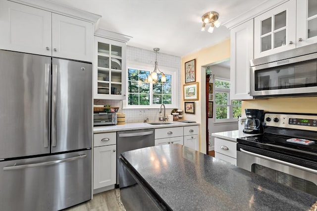 39 Bennets Neck Dr, Bourne, MA 02559 - kitchen with stainless steel appliances, white cabinets, light wood-style floors, and glass insert cabinets