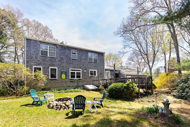 39 Bennets Neck Dr, Bourne, MA 02559 - back of house with a wooden deck, an outdoor fire pit, and a yard