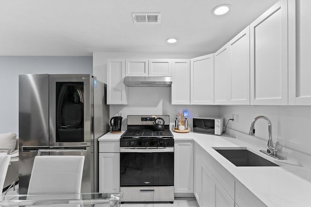 kitchen featuring white cabinets, appliances with stainless steel finishes, and sink