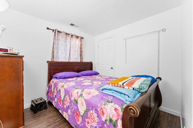 bedroom with dark hardwood / wood-style floors