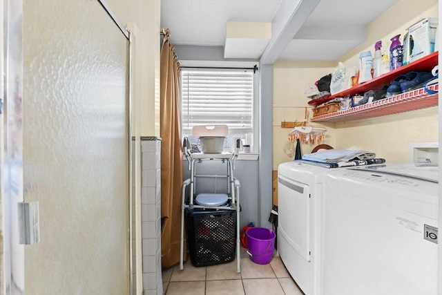 clothes washing area with independent washer and dryer and light tile patterned flooring