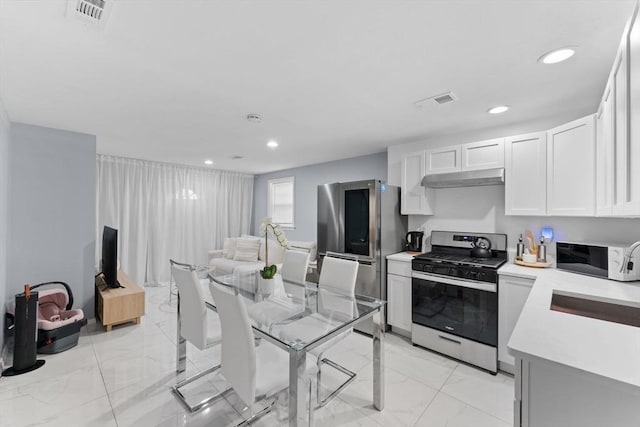 kitchen with white cabinetry and appliances with stainless steel finishes