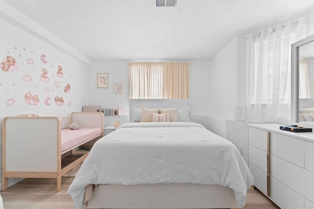 bedroom with light wood-type flooring