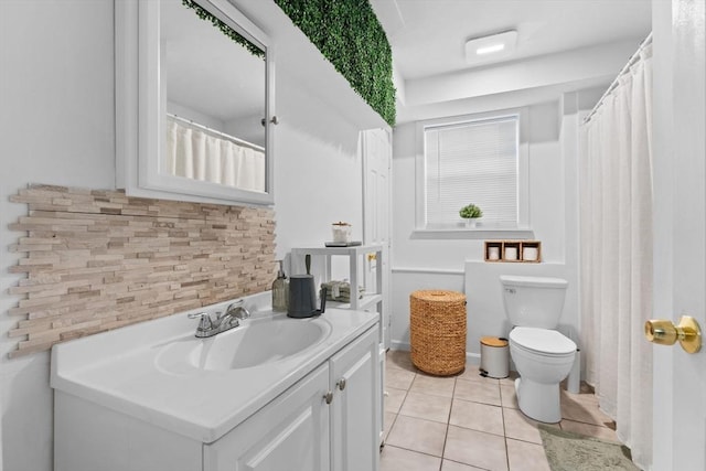 bathroom featuring tile patterned flooring, vanity, toilet, and decorative backsplash