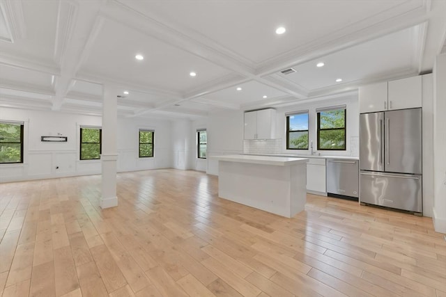 126 Central St Unit 2, Somerville, MA 02145 - kitchen with stainless steel appliances, open floor plan, coffered ceiling, light countertops, and a kitchen island
