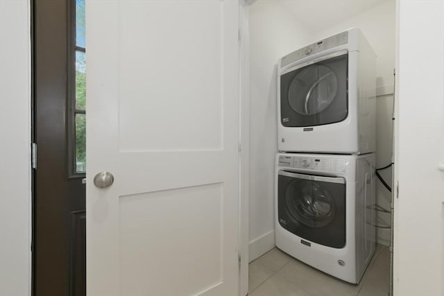 126 Central St Unit 2, Somerville, MA 02145 - laundry room with stacked washer / dryer and light tile patterned flooring