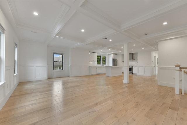 126 Central St Unit 2, Somerville, MA 02145 - unfurnished living room with a decorative wall, coffered ceiling, beamed ceiling, and light wood-style floors