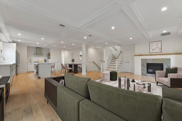 126 Central St Unit 2, Somerville, MA 02145 - living area with coffered ceiling, light wood-type flooring, stairway, a fireplace, and recessed lighting