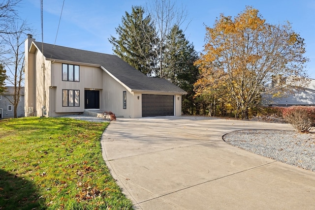 view of front of home featuring a garage and a front yard