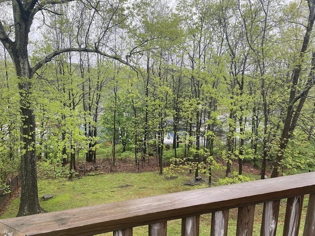 view of green lawn featuring a view of trees