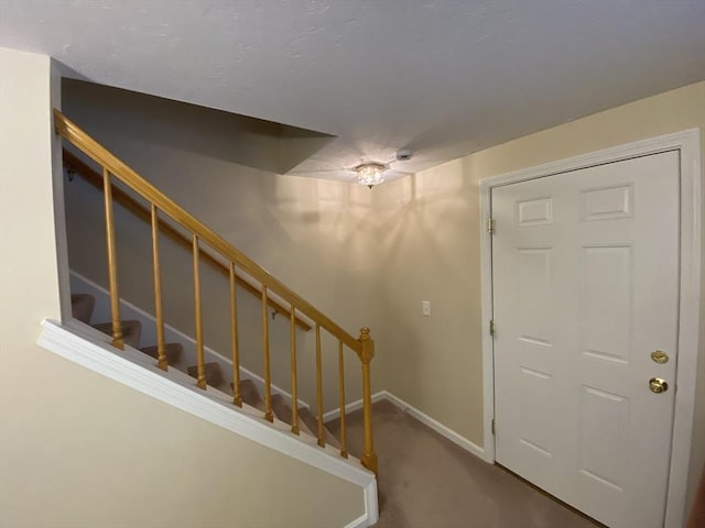 stairway with carpet flooring and baseboards