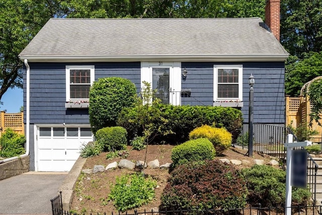 31 Whitman Ave, Melrose, MA 02176 - view of front of home with a chimney, a garage, asphalt driveway, and roof with shingles