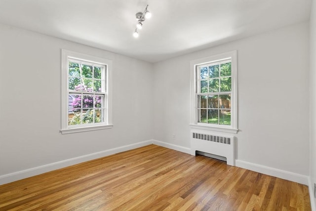 31 Whitman Ave, Melrose, MA 02176 - unfurnished room featuring radiator heating unit, healthy amount of natural light, and baseboards