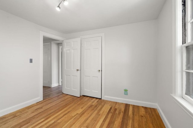 31 Whitman Ave, Melrose, MA 02176 - unfurnished bedroom with baseboards and light wood-type flooring