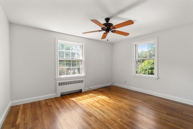 31 Whitman Ave, Melrose, MA 02176 - empty room featuring radiator, healthy amount of natural light, wood finished floors, and baseboards
