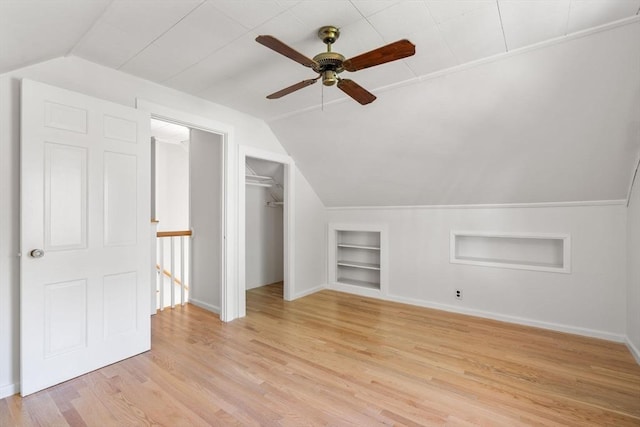 31 Whitman Ave, Melrose, MA 02176 - additional living space with built in features, vaulted ceiling, light wood-type flooring, baseboards, and a ceiling fan