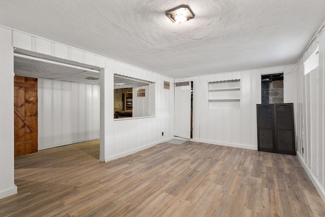31 Whitman Ave, Melrose, MA 02176 - finished below grade area with wood finished floors, built in features, baseboards, and a decorative wall