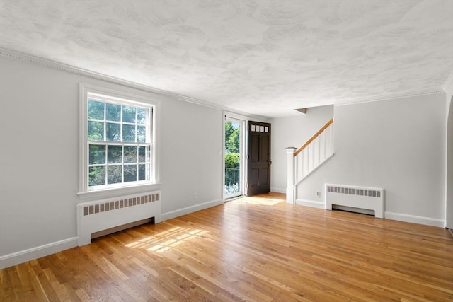 31 Whitman Ave, Melrose, MA 02176 - foyer featuring radiator heating unit, stairs, wood finished floors, baseboards, and crown molding