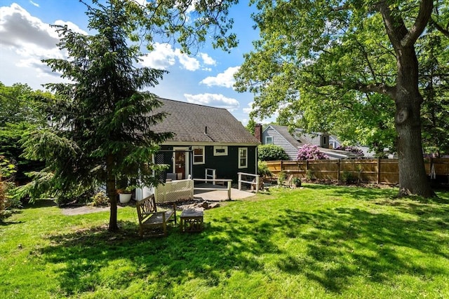 31 Whitman Ave, Melrose, MA 02176 - back of property with a patio area and roof with shingles