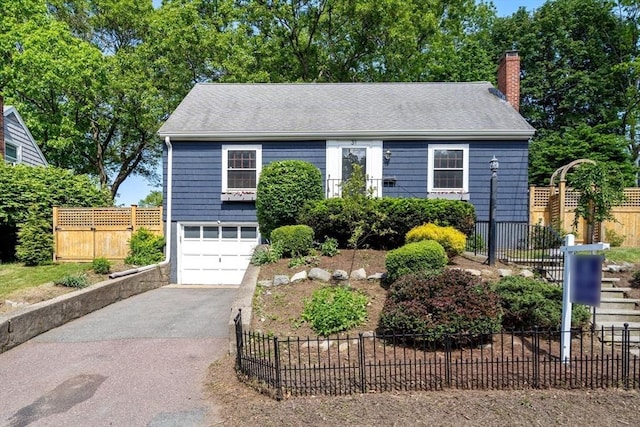 31 Whitman Ave, Melrose, MA 02176 - view of front of house featuring driveway, a chimney, a garage, and a shingled roof