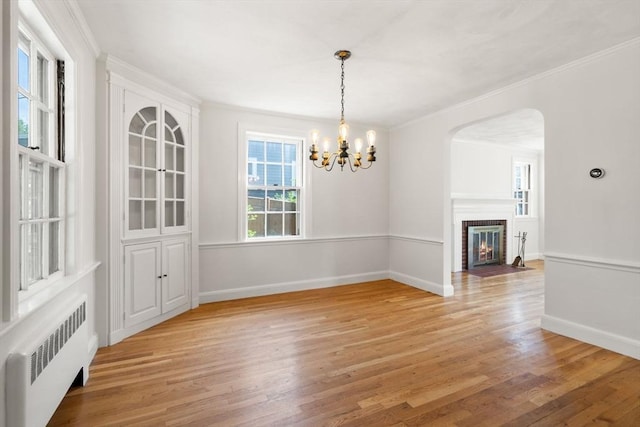 31 Whitman Ave, Melrose, MA 02176 - unfurnished dining area featuring radiator, light wood-style floors, crown molding, a chandelier, and baseboards