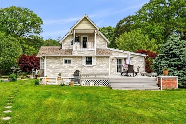 31 Rydberg Ter, Auburn, MA 01607 - rear view of property featuring stone siding, a balcony, a lawn, and a wooden deck