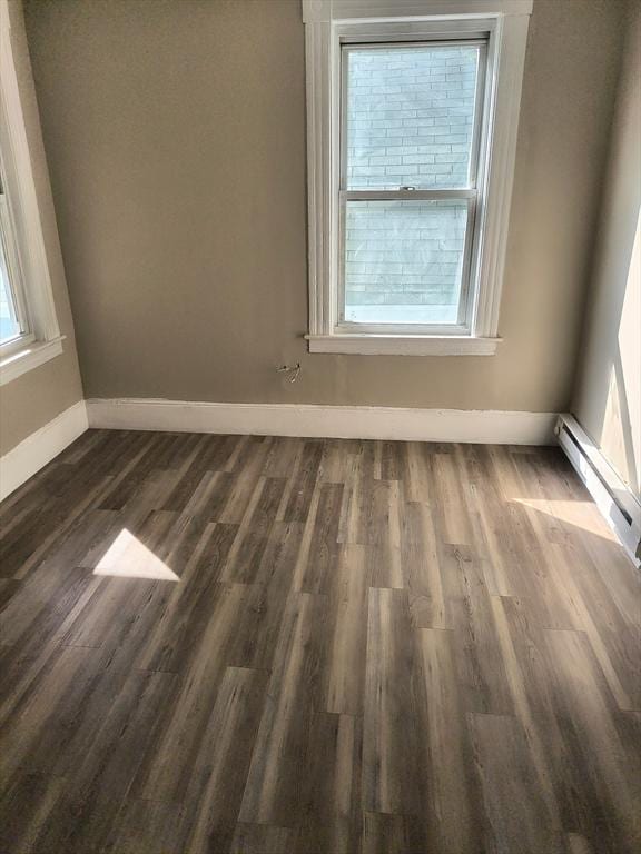 43 Cedar St, Lowell, MA 01852 - empty room with baseboards, a baseboard heating unit, and dark wood-type flooring