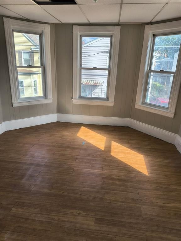 43 Cedar St, Lowell, MA 01852 - unfurnished room featuring baseboards, dark wood-style flooring, and a drop ceiling
