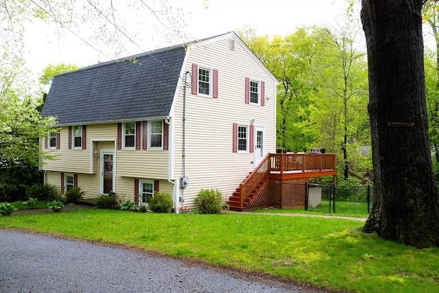 49 Tremont St, Billerica, MA 01821 - view of front facade with a deck, stairway, roof with shingles, and a gambrel roof