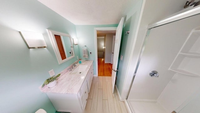 49 Tremont St, Billerica, MA 01821 - bathroom featuring a shower stall, vanity, and wood finished floors