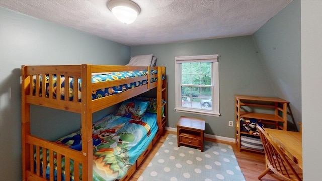 49 Tremont St, Billerica, MA 01821 - bedroom with a textured ceiling, wood finished floors, and baseboards