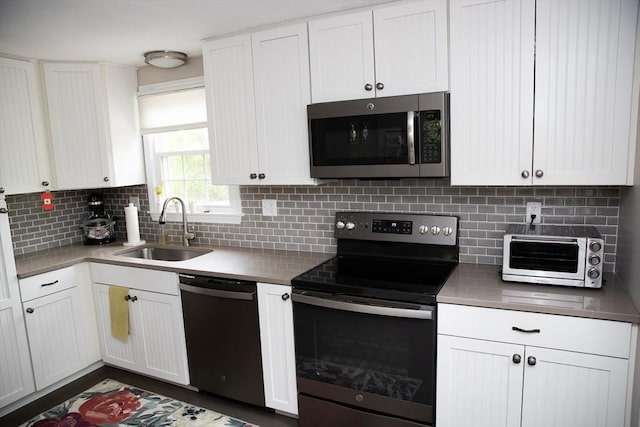 49 Tremont St, Billerica, MA 01821 - kitchen featuring stainless steel appliances, a sink, white cabinetry, and backsplash