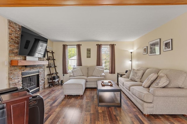 living room featuring dark wood-style floors and a stone fireplace