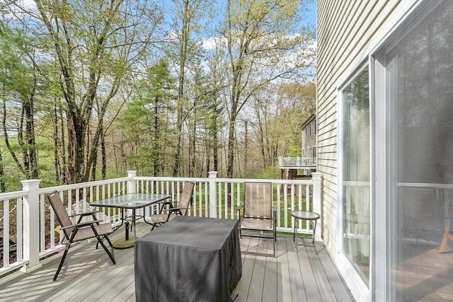 deck with outdoor dining area