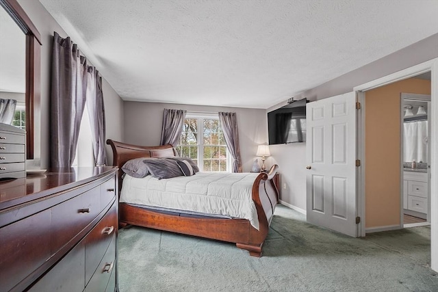 bedroom featuring a textured ceiling, carpet flooring, and baseboards