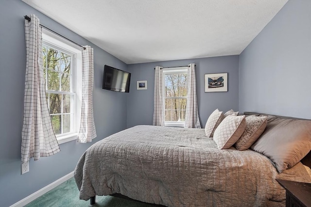 carpeted bedroom featuring baseboards