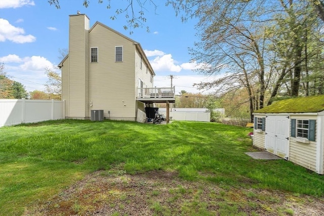 back of property featuring a chimney, central AC, and a deck