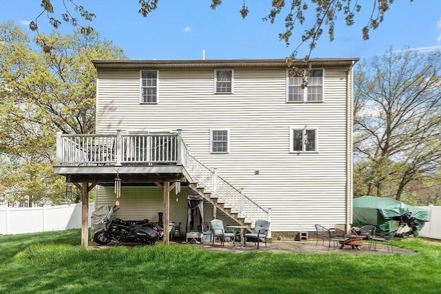 rear view of house featuring stairs, a wooden deck, and a patio