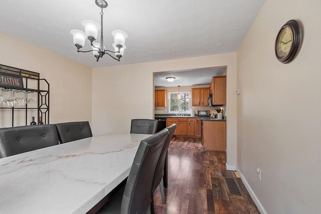 dining space featuring a chandelier, dark wood-type flooring, and baseboards