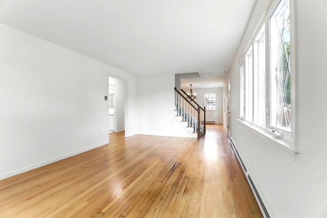 14 Provin Mountain Dr, Agawam, MA 01030 - unfurnished living room featuring stairway, light wood-style floors, baseboards, and baseboard heating