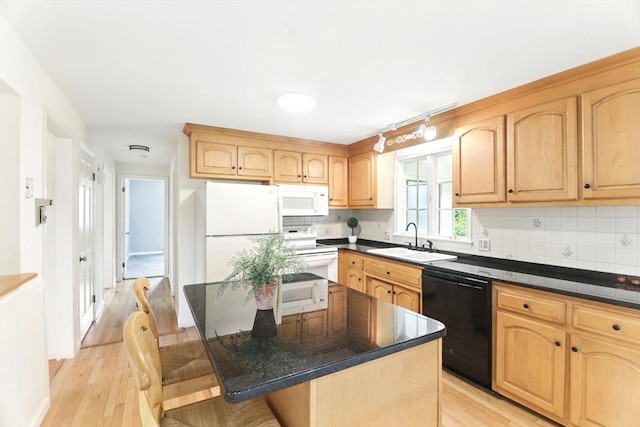 14 Provin Mountain Dr, Agawam, MA 01030 - kitchen with white appliances, a sink, tasteful backsplash, light wood finished floors, and dark countertops
