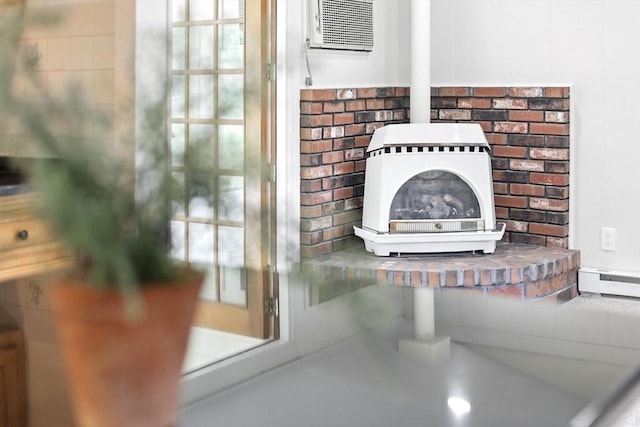 14 Provin Mountain Dr, Agawam, MA 01030 - detailed view of a wood stove, baseboard heating, and a wall mounted air conditioner