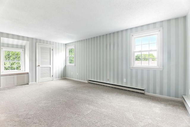 14 Provin Mountain Dr, Agawam, MA 01030 - spare room with a baseboard radiator, wallpapered walls, carpet, a textured ceiling, and baseboards