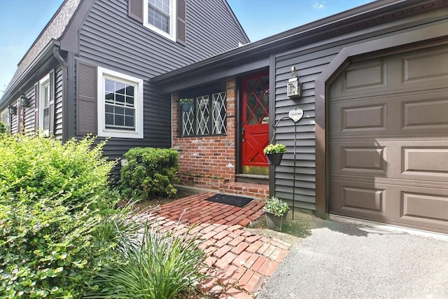 14 Provin Mountain Dr, Agawam, MA 01030 - property entrance featuring driveway, brick siding, and a garage